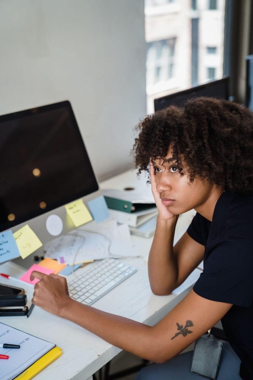 ADHD in Adults: Signs You Might Have Missed and How Therapy Helps 1 Adult sitting by a window looking thoughtful while reflecting on possible ADHD symptoms