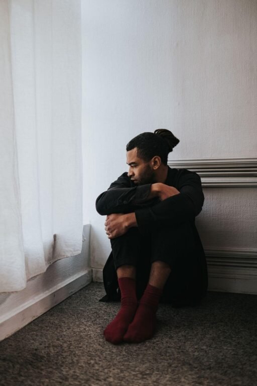 Person sitting quietly processing difficult emotions early in therapy