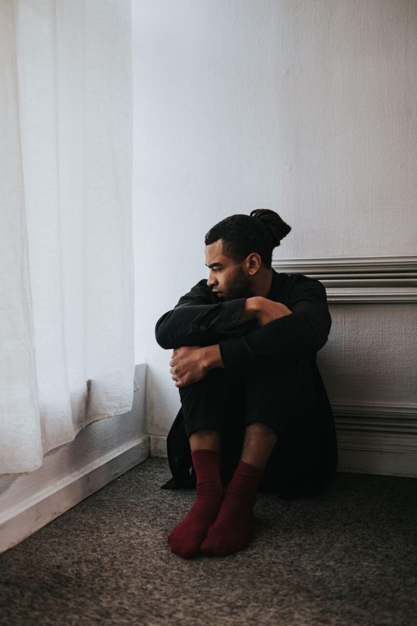 Person sitting quietly processing difficult emotions early in therapy